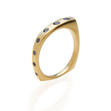 Our Wrapped with Sapphires Ring is like a blue waterfall flowing down your finger.&nbsp;Minimalistic in design and easy to wear with a low profile. Hand carved and cast in responsibly sourced&nbsp;recycled gold and set with&nbsp;7 round&nbsp;Australian&nbsp;Sapphires.

Our gemstones are responsibly mined and cut,&nbsp;supporting mining and cutting communities. Learn about what this means when it comes to&nbsp;our jewelry supply chains.

Comfortable fit with a soft brushed finish and square bottom.

.23tcw 